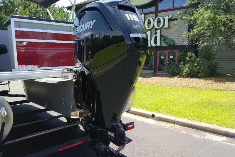 Slide: The Image of 2026 Sun Tracker SportFish 20 DLX with Mercury 115 outboard motor, parked outdoors. - 4
