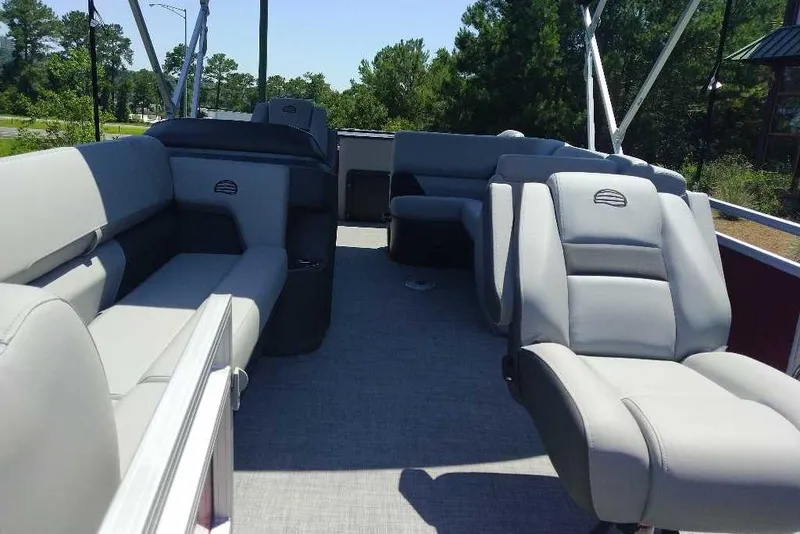Slide: The Image of 2026 Sun Tracker SportFish 20 DLX pontoon boat interior with plush seating and open layout. - 6