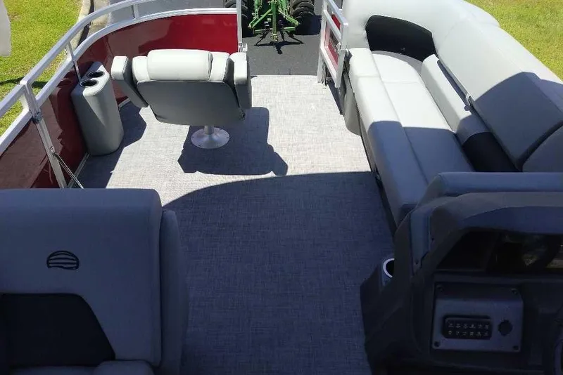 Slide: The Image of 2026 Sun Tracker SportFish 20 DLX pontoon boat interior with seating and helm. - 8