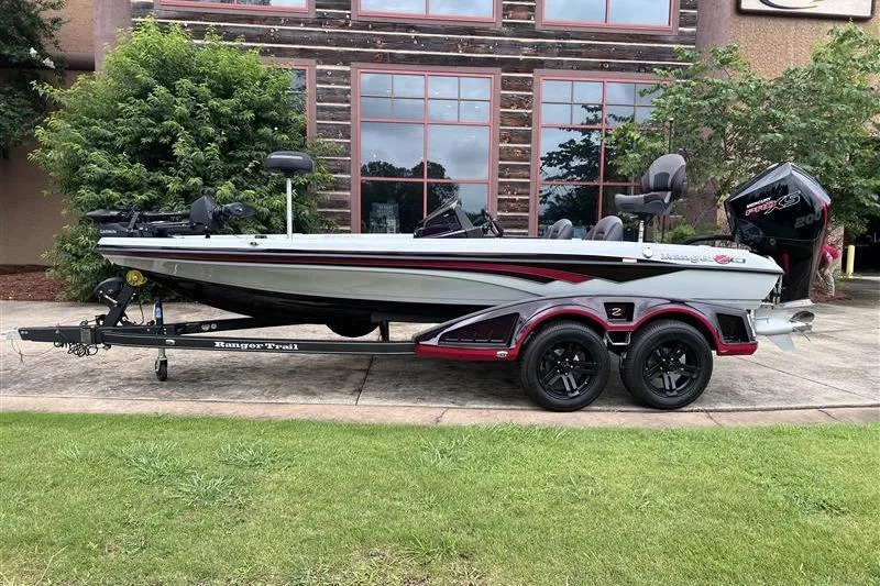 Slide: The Image of 2026 Ranger Z518 Cup-Equipped boat on trailer, parked outdoors near building. - 1