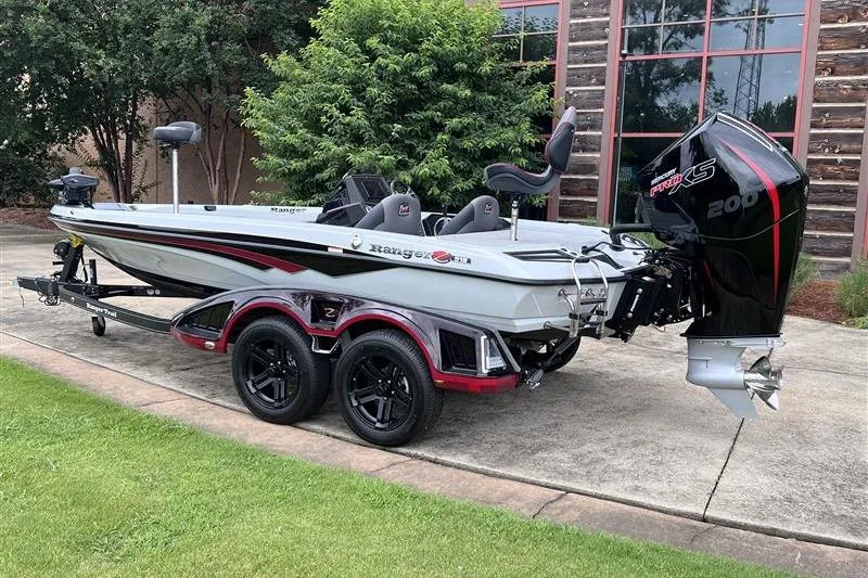 Slide: The Image of 2026 Ranger Z518 Cup-Equipped boat with powerful engine, parked on a trailer. - 2