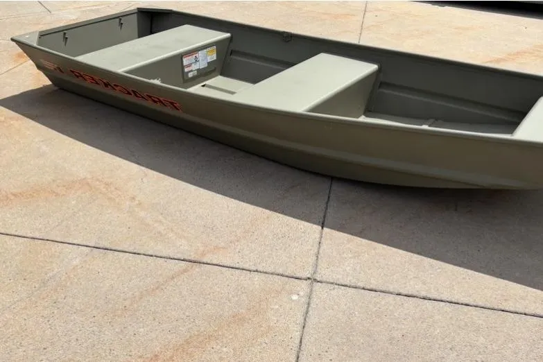 The Image of 2026 Tracker Grizzly 12 Jon boat on concrete surface, showcasing its sturdy design. - 0