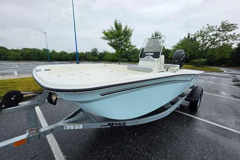 The Image of 2026 Mako Pro Skiff 15 CC boat on trailer in parking lot. - 0