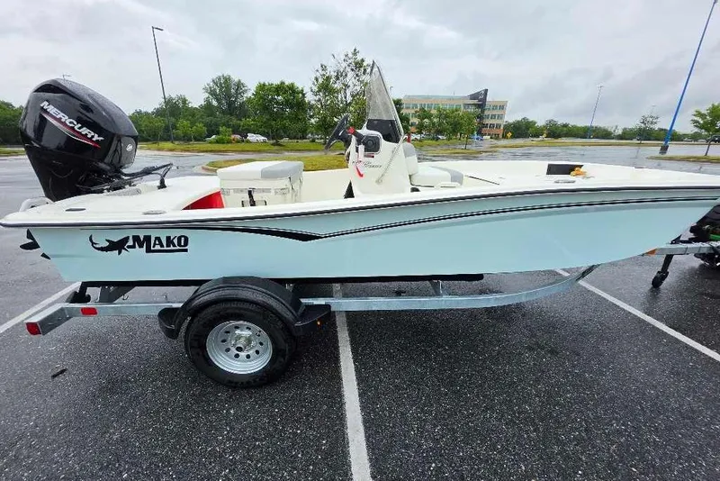 Slide: The Image of 2026 Mako Pro Skiff 15 CC boat on trailer in parking lot. - 2