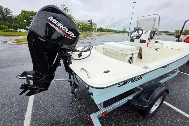 Slide: The Image of 2026 Mako Pro Skiff 15 CC boat with Mercury outboard motor on trailer. - 4