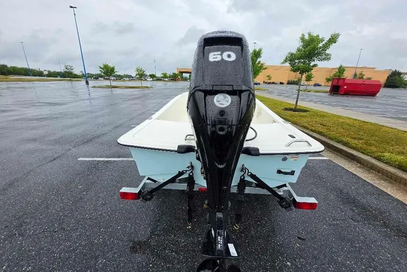 Slide: The Image of 2026 Mako Pro Skiff 15 CC with 50 HP engine in parking lot. - 6
