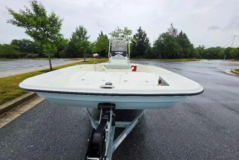 Slide: The Image of 2026 Mako Pro Skiff 15 CC boat on trailer in parking lot. - 7