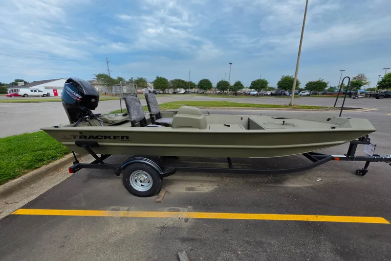 The Image of 2026 Tracker Grizzly 1754 SC boat on trailer in parking lot, side view. - 0