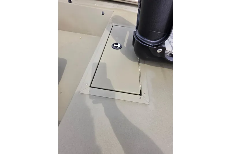 Slide: The Image of 2026 Tracker Grizzly 1754 SC boat storage compartment with secure latch. - 6