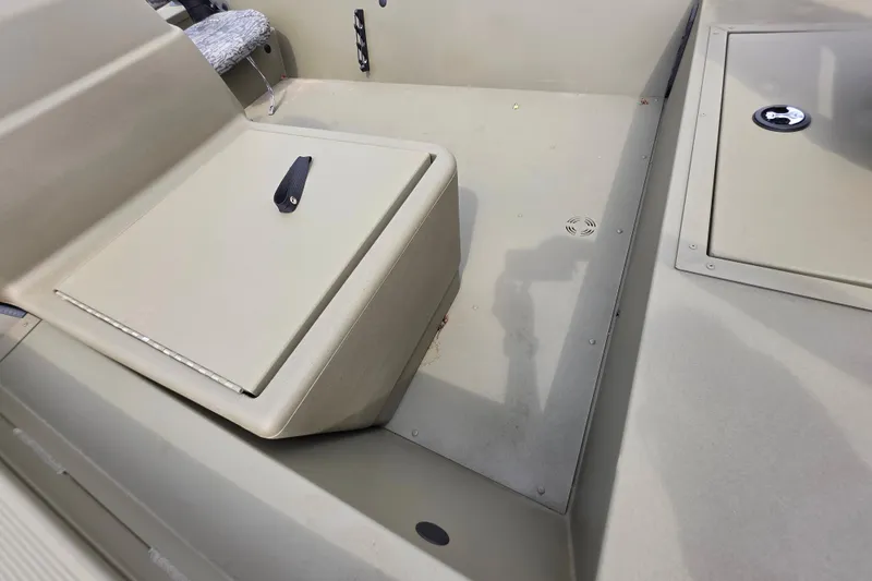 Slide: The Image of 2026 Tracker Grizzly 1754 SC boat interior with storage compartments and seating. - 7