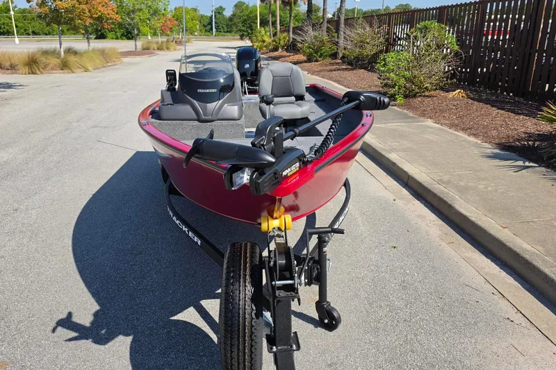 Slide: The Image of 2026 Tracker Super Guide V-16 SC boat on trailer, parked on a sunny street. - 5