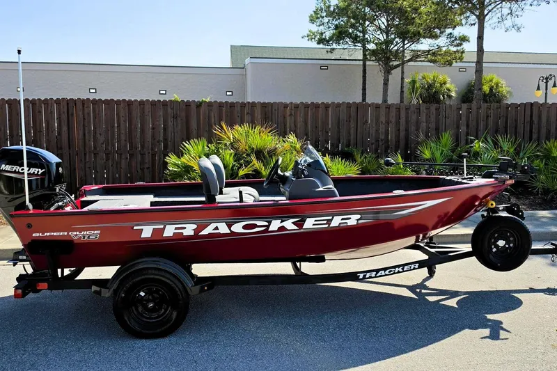 Slide: The Image of 2026 Tracker Super Guide V-16 SC boat on trailer, parked outdoors. - 11