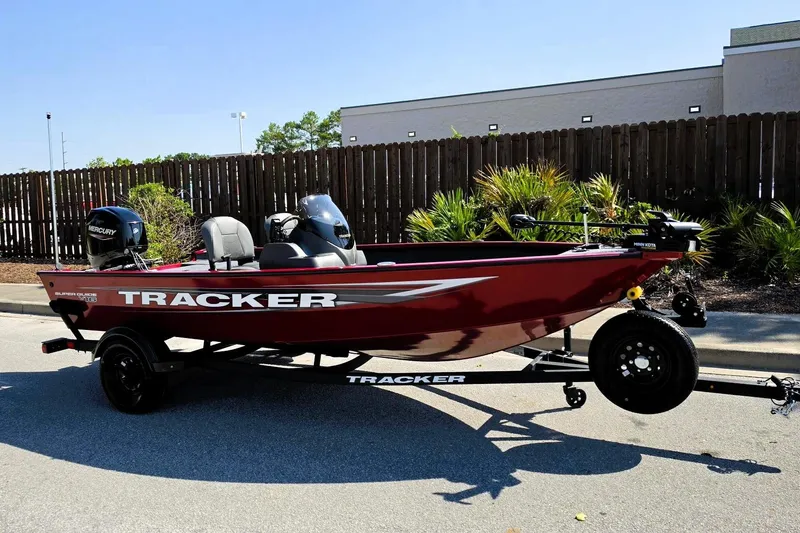 Slide: The Image of 2026 Tracker Super Guide V-16 SC boat on trailer, parked outdoors. - 2