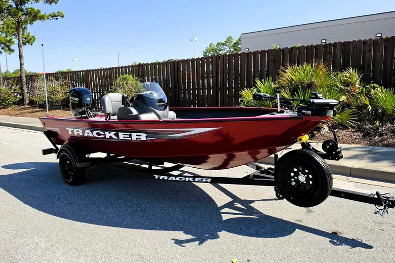 Slide: The Image of 2026 Tracker Super Guide V-16 SC boat on trailer, parked outdoors. - 3