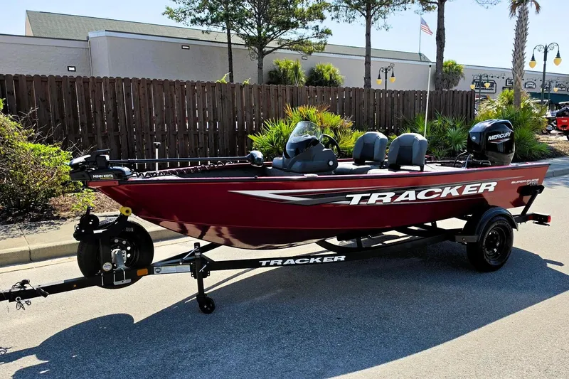Slide: The Image of 2026 Tracker Super Guide V-16 SC boat on trailer, parked outdoors. - 8
