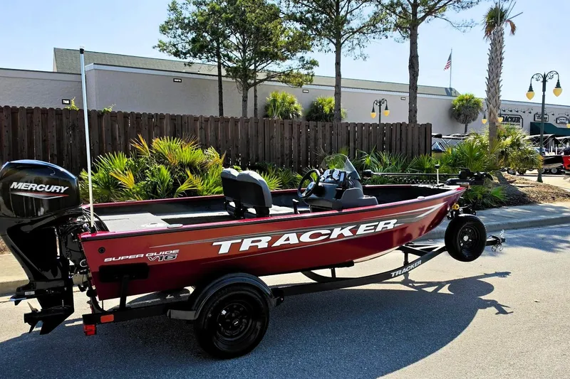 Slide: The Image of 2026 Tracker Super Guide V-16 SC boat on trailer, parked outdoors. - 12
