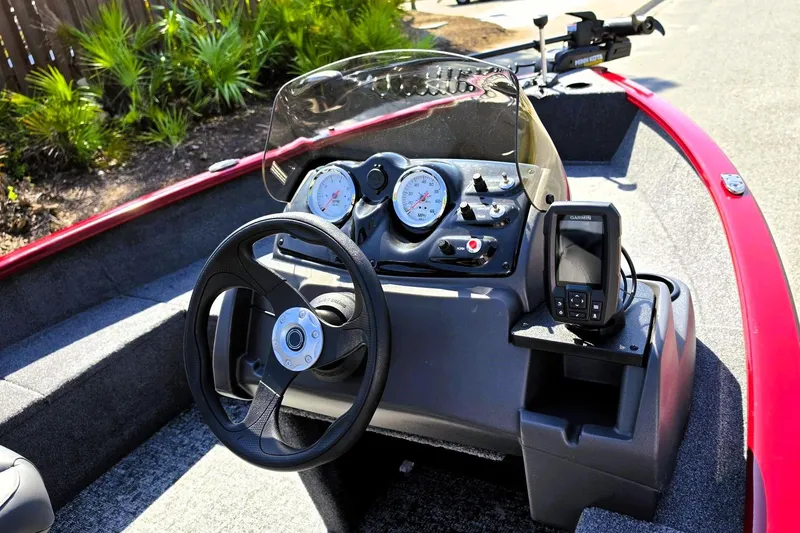 Slide: The Image of 2026 Tracker Super Guide V-16 SC boat dashboard with steering wheel and navigation system. - 9