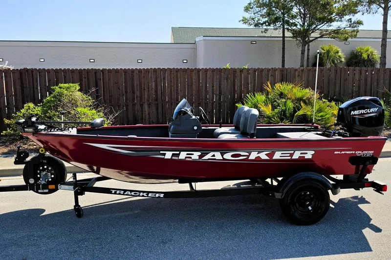 Slide: The Image of 2026 Tracker Super Guide V-16 SC boat on trailer, parked outdoors. - 7