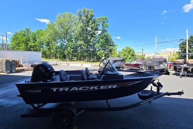 Slide: The Image of 2026 Tracker Pro Guide V-175 WT boat on trailer, parked outdoors under clear blue sky. - 3