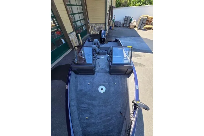 Slide: The Image of 2026 Tracker Pro Guide V-175 WT boat parked outdoors, showcasing spacious deck and seating. - 5