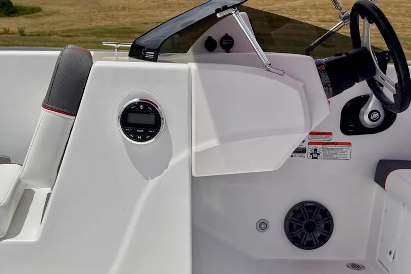 Slide: The Image of 2026 Tahoe T18 boat dashboard with steering wheel and control panel. - 7