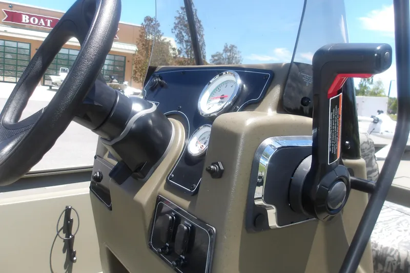 Slide: The Image of Steering console of 2026 Tracker Grizzly 1860 CC boat with gauges and controls. - 15
