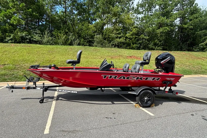The Image of Red 2026 Tracker Pro Team 175 Crappie Edition boat on trailer in parking lot. - 0
