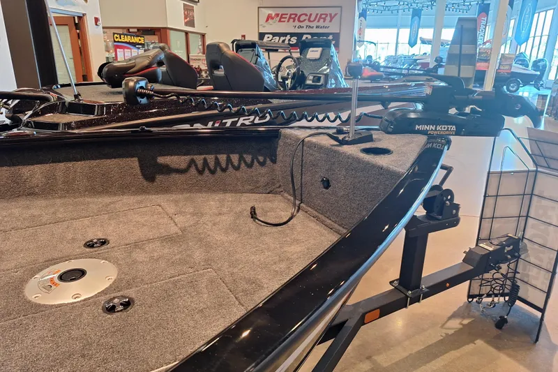 Slide: The Image of 2026 Tracker Super Guide V-16 T boat with Minn Kota motor in showroom display. - 3