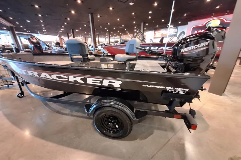 Slide: The Image of 2026 Tracker Super Guide V-16 T boat with Mercury engine displayed indoors. - 5