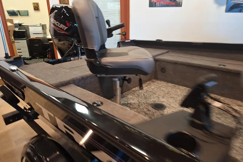 Slide: The Image of 2026 Tracker Super Guide V-16 T boat interior with Mercury engine, featuring a comfortable seat. - 6
