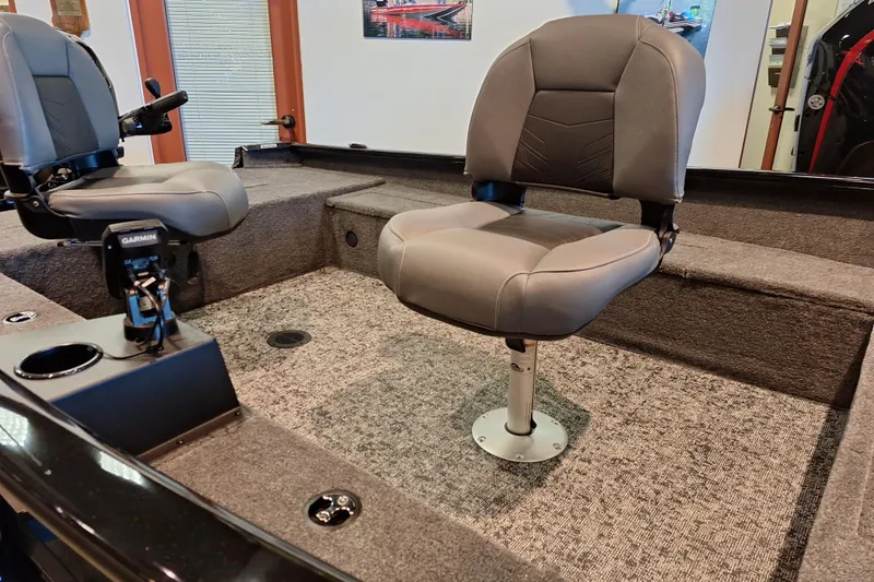 Slide: The Image of Interior of 2026 Tracker Super Guide V-16 T boat with seating and Garmin equipment. - 7