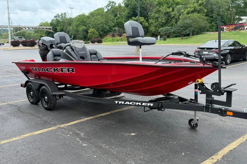 Slide: The Image of Red 2026 Tracker Pro Team 195 boat on trailer in parking lot. - 7