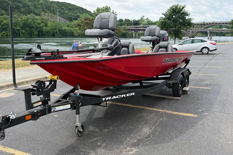 Slide: The Image of Red 2026 Tracker Pro Team 195 boat on trailer by riverside parking lot. - 9