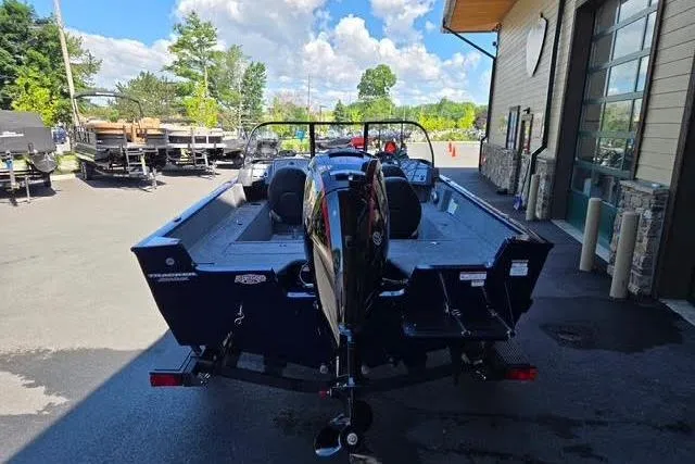 Slide: The Image of 2026 Tracker Pro Guide V-175 WT boat parked outdoors on a sunny day. - 2