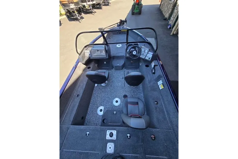 Slide: The Image of 2026 Tracker Pro Guide V-175 WT boat interior with seating and steering console. - 3