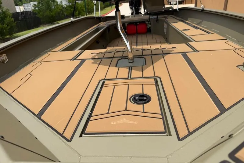 Slide: The Image of 2026 Tracker Grizzly 1756 T Marsh boat interior with tan deck and storage compartments. - 16