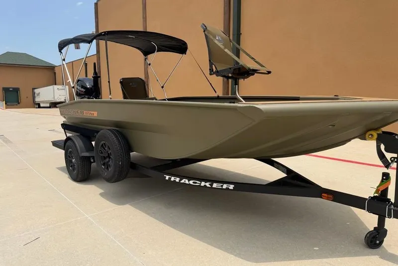 Slide: The Image of 2026 Tracker Grizzly 1756 T Marsh boat on trailer, parked outdoors. - 6