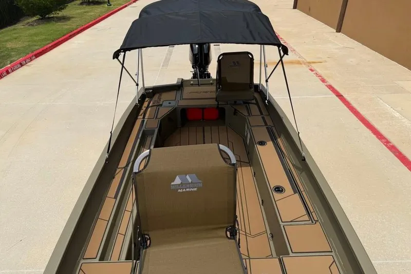 Slide: The Image of 2026 Tracker Grizzly 1756 T Marsh boat with canopy on a concrete surface. - 12