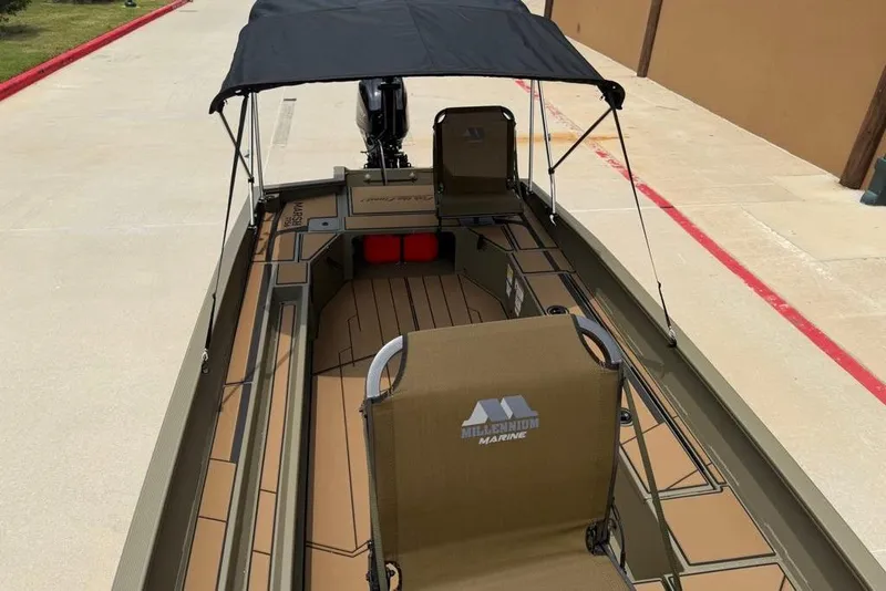 Slide: The Image of 2026 Tracker Grizzly 1756 T Marsh boat with canopy and Millennium Marine seating. - 11