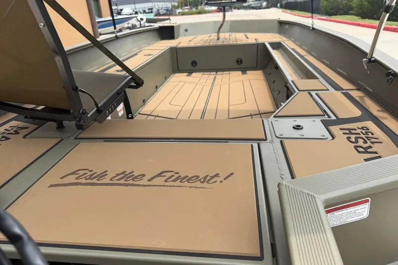 Slide: The Image of 2026 Tracker Grizzly 1756 T Marsh boat interior with "Fish the Finest!" slogan. - 7