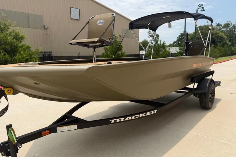 Slide: The Image of 2026 Tracker Grizzly 1756 T Marsh boat on trailer, parked outdoors. - 2