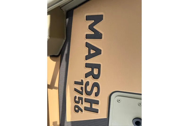 Slide: The Image of Close-up of 2026 Tracker Grizzly 1756 T Marsh boat logo in bold lettering. - 13