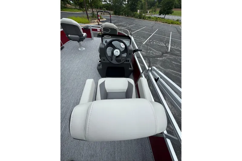 Slide: The Image of 2026 Sun Tracker Bass Buggy 16 XL Select boat interior with steering console and seating. - 9