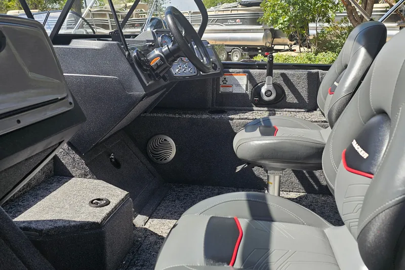 Slide: The Image of 2026 Tracker Pro Guide V-175 Combo boat interior with steering wheel and seating. - 14