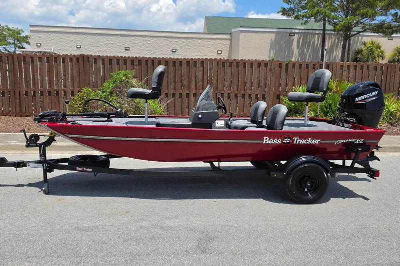 Slide: The Image of 2026 Tracker Bass Tracker Classic XL boat on trailer, red exterior, parked outdoors. - 6
