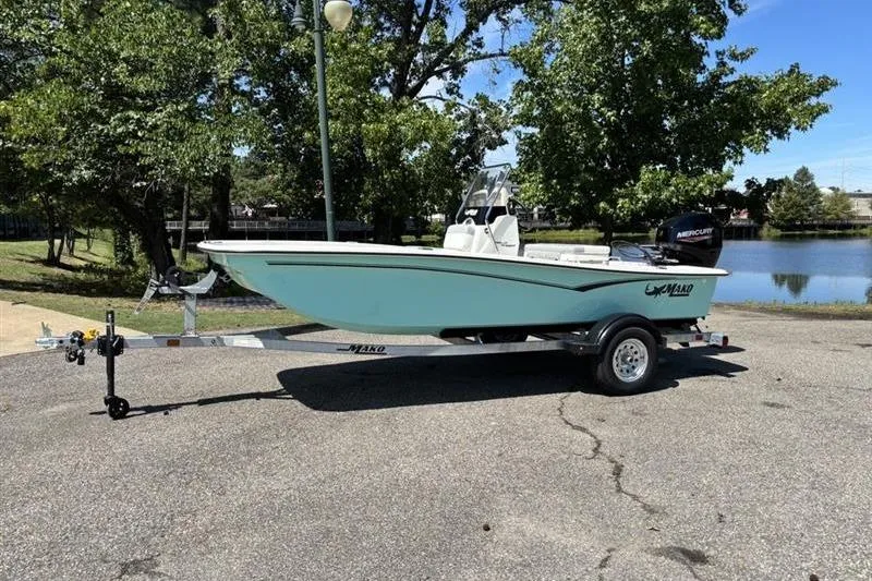 The Image of 2026 Mako Pro Skiff 15 CC boat on trailer, parked near a scenic lake. - 0