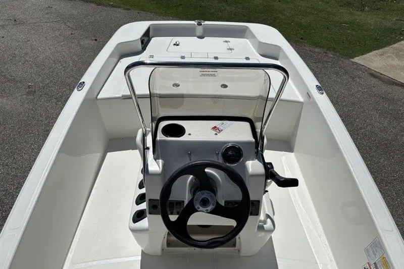 Slide: The Image of 2026 Mako Pro Skiff 15 CC boat interior with steering console and seating. - 10