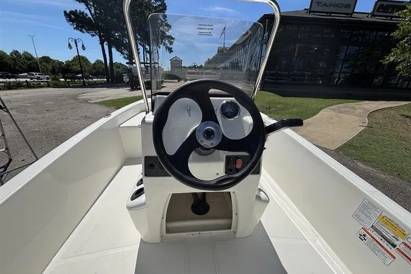 Slide: The Image of 2026 Mako Pro Skiff 15 CC boat console with steering wheel and controls. - 11