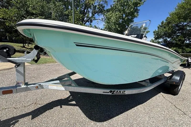 Slide: The Image of 2026 Mako Pro Skiff 15 CC on trailer, light blue hull, parked outdoors. - 3