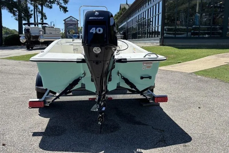 Slide: The Image of 2026 Mako Pro Skiff 15 CC with Mercury 40 engine on trailer, parked outdoors. - 6